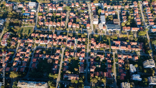 Aerial drone sunrise view of suburban houses. Aerial view of tightly located new family houses in suburban area. Real estate development in american suburbs