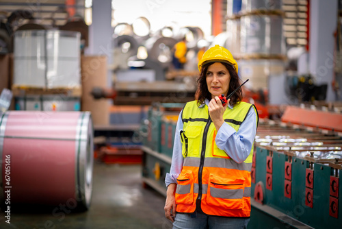 Young female engineer in metal sheet factory Responsible work is being inspected at the actual work site