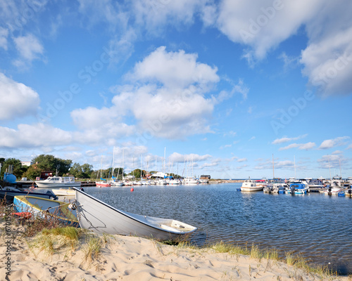 A group of boats sitting on top of a sandy beach. Neeme harbor in Northern Estonia. photo