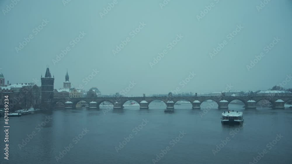 landscape in winter in Prague, Czech Republic with Vltava river, Karlov most and boat in the evening. landscape in winter in Prague, Czech Republic with Vltava river, Karlov most and boat in the evening.