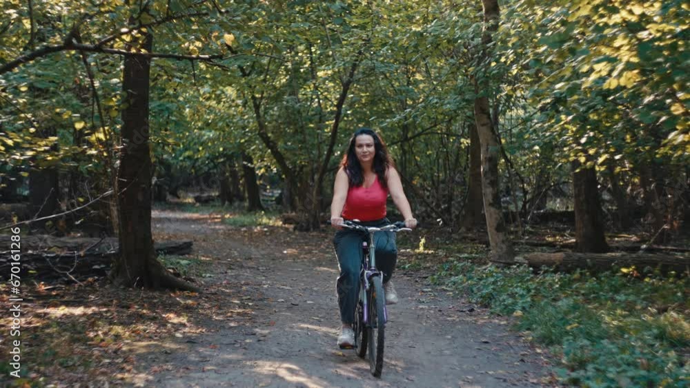 Day of Adventure: A Fit and Energetic Woman Engages in a Spirited Bike Ride Amidst Nature's Beauty. High quality 4k footage Day of Adventure: A Fit and Energetic Woman Engages in a Spirited Bike Ride Amidst Nature's Beauty. High quality 4k footage