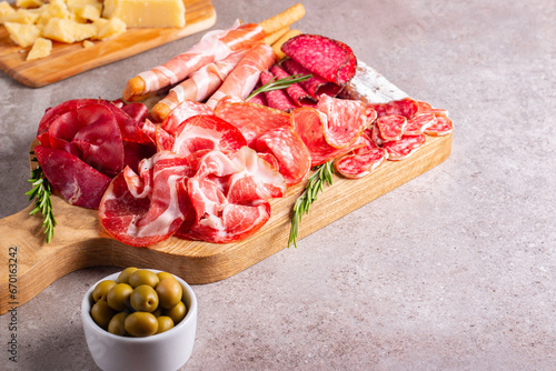 Charcuterie board. Antipasti appetizers of meat platter with salami, prosciutto crudo or jamon and olives