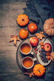 Cup of hot tea with pumpkins and autumn fruits. Happy Thanksgiving and Hello fall concept