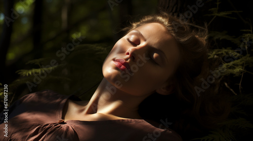 woman eyes closed dreaming in the forest photo