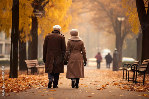Elderly Love Couple walking in the Autumn Park, view from behind