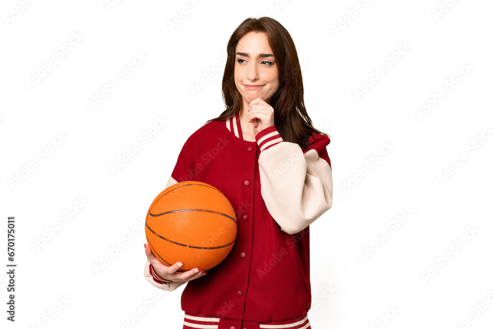 Young basketball player woman over isolated chroma key background having doubts and thinking