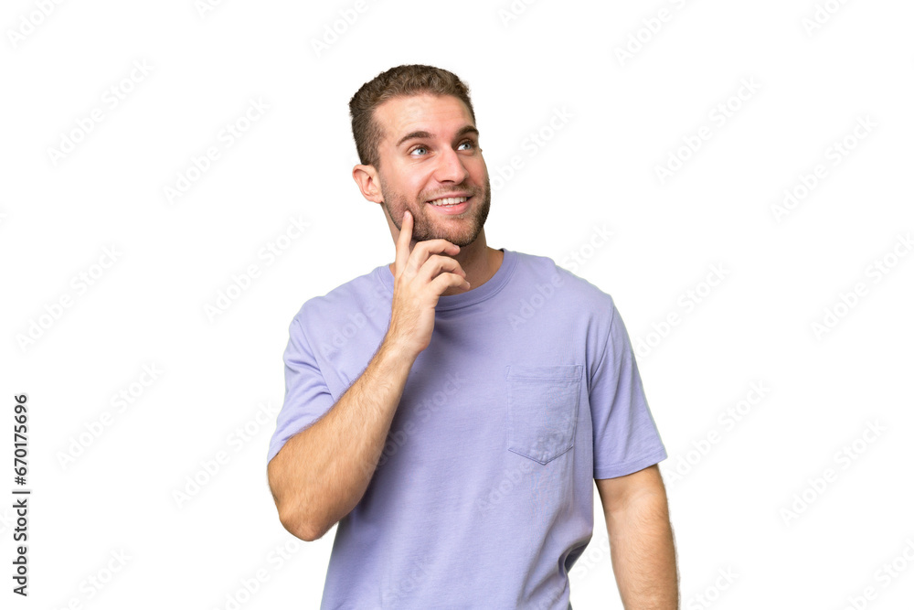 Young handsome caucasian man isolated on green chroma background thinking an idea while looking up Young handsome caucasian man isolated on green chroma background thinking an idea while looking up