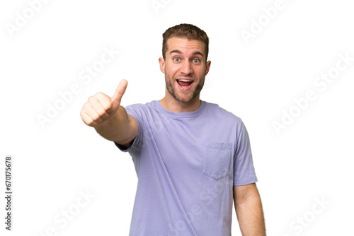 Young handsome caucasian man isolated on green chroma background with thumbs up because something good has happened