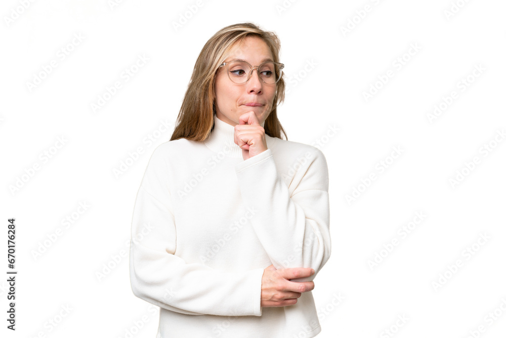 Young blonde woman over isolated background having doubts and thinking Young blonde woman over isolated background having doubts and thinking