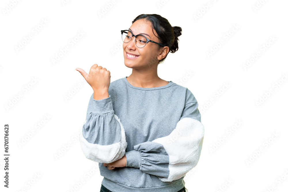 Young Uruguayan woman over isolated chroma key background pointing to the side to present a product Young Uruguayan woman over isolated chroma key background pointing to the side to present a product