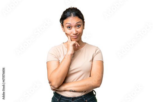 Young Uruguayan woman over isolated chroma key background and thinking