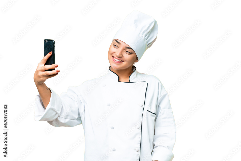 Young woman Chef over isolated chroma key background making a selfie Young woman Chef over isolated chroma key background making a selfie