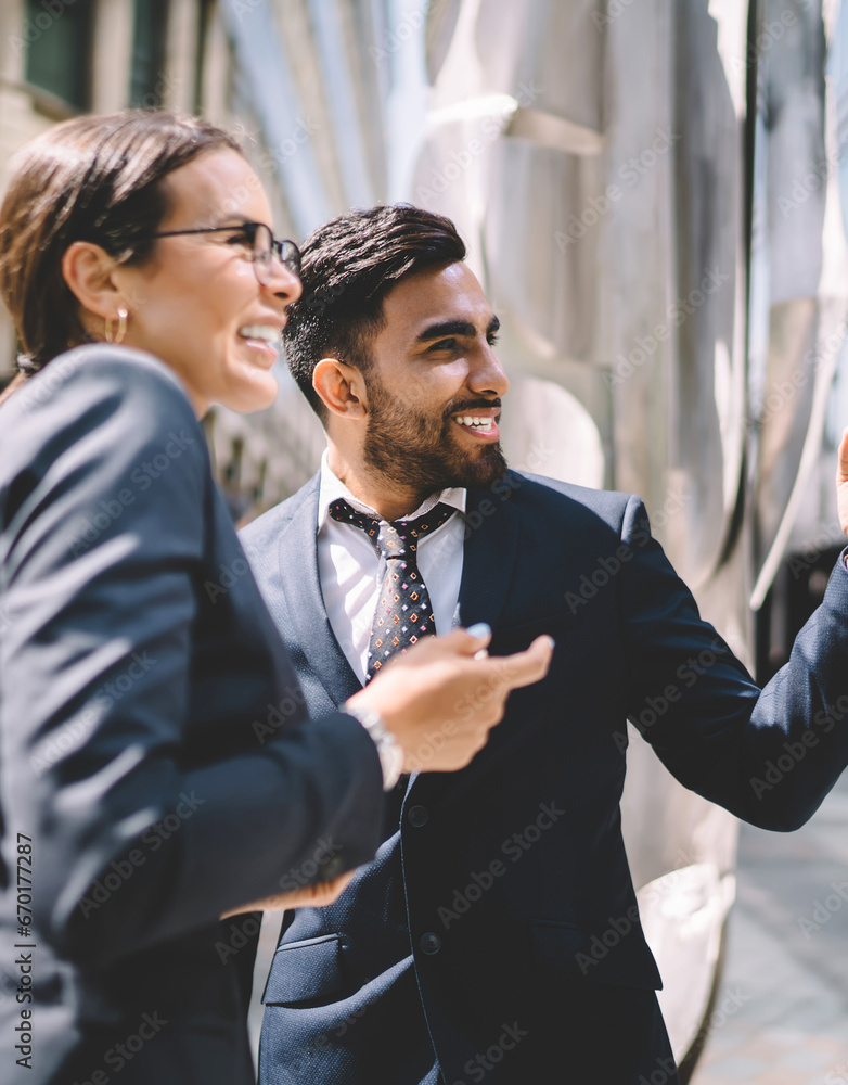 Successful smiling spanish male owner of corporate company pointing Successful smiling spanish male owner of corporate company pointing