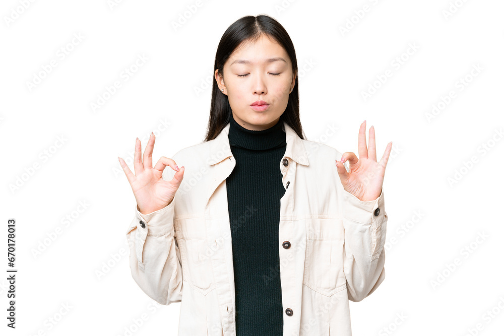 Young Asian woman over isolated chroma key background in zen pose Young Asian woman over isolated chroma key background in zen pose