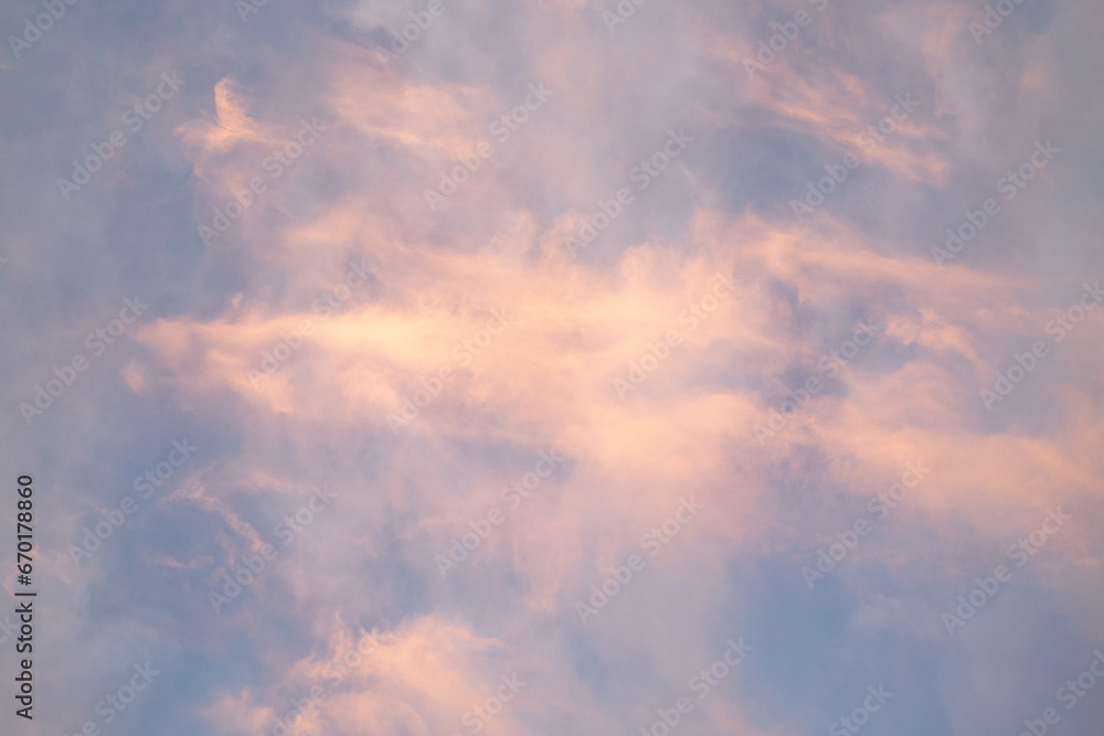 Blue sky with pink sunset clouds. Cloud texture, background.