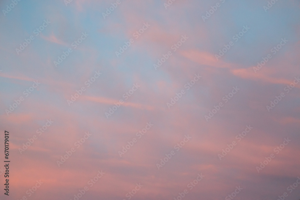 Blue sky with pink sunset clouds. Cloud texture, background.