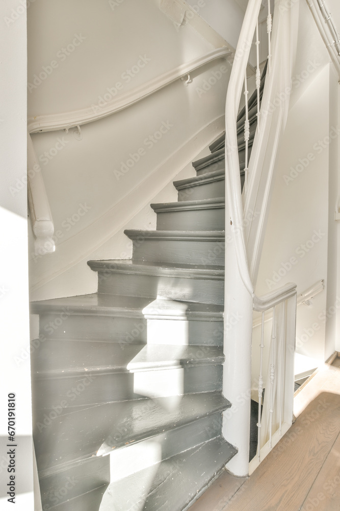 Empty grey staircase in white house Empty grey staircase in white house