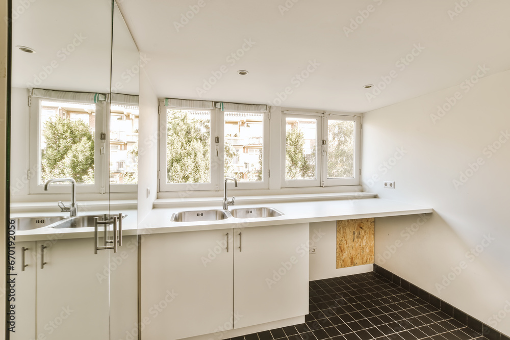 Interior of empty white kitchen with windows Interior of empty white kitchen with windows