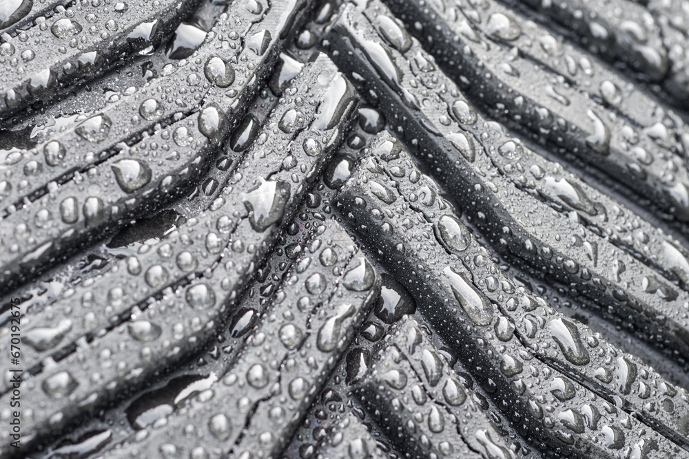 Car tyre with waterdrops on the entire surface. Automotive background cover