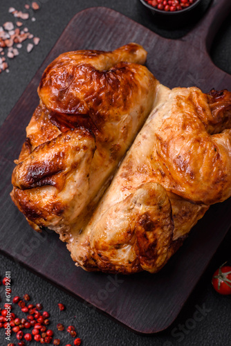 Crispy delicious whole baked chicken with vegetables, salt and spices