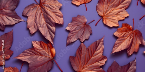 Pattern of dry orange metallic leaves on violet background. 