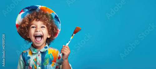 cute kid holding paint brush on blue color background, generative ai photo