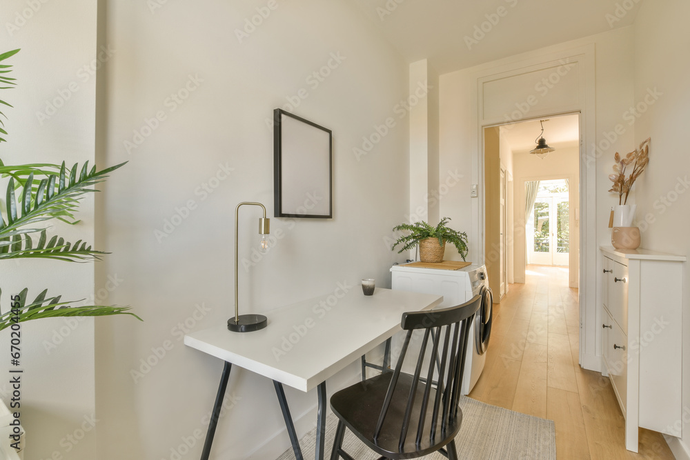 Home office with chair and desk by washing machine Home office with chair and desk by washing machine