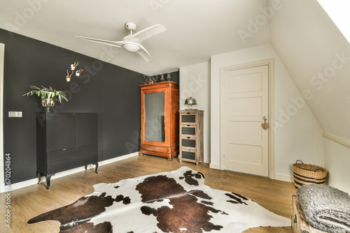 Living room with black wall and cow skin rug on floor
