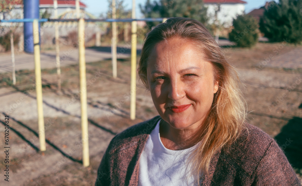Obraz premium street portrait of a cute adult woman of European appearance, natural blonde, selective focus