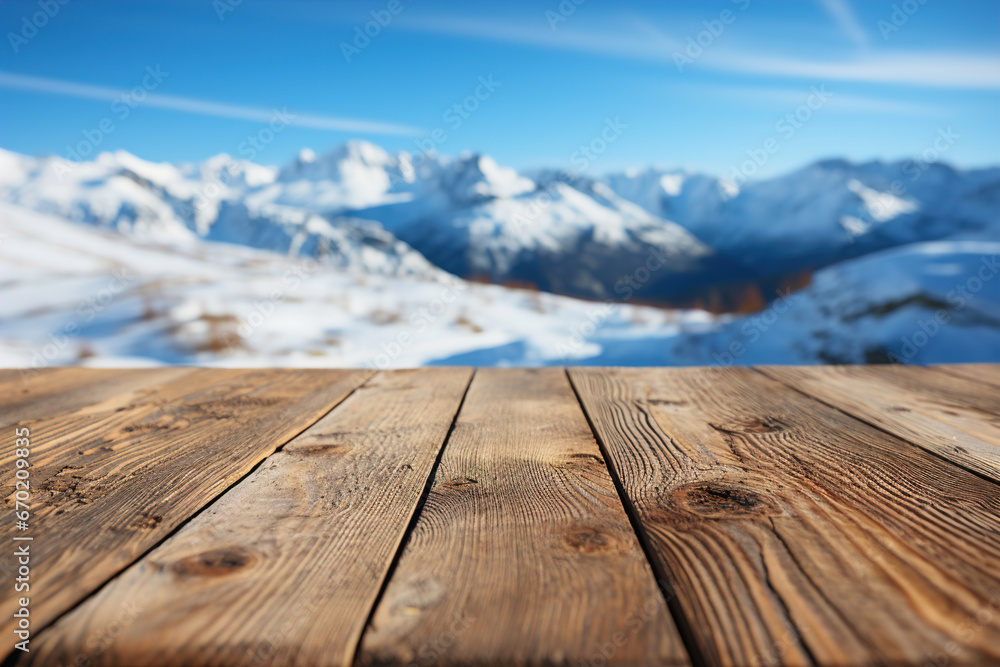 A wooden table boards and blurred defocused snow covered mountains view in the background. A wooden table boards and blurred defocused snow covered mountains view in the background.