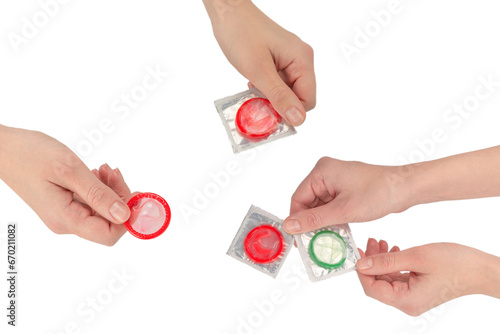 Condom in woman hand isolated on white background.