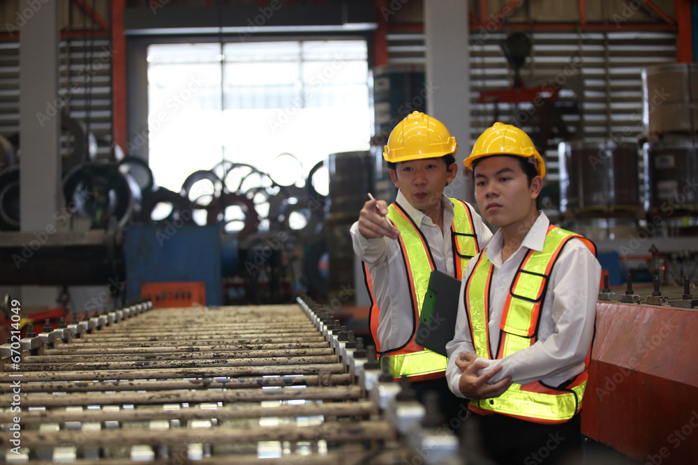 worker or engineer working in factory with safety uniform , safety hat and safety glasses , image is safety concept or happy workplace worker or engineer working in factory with safety uniform , safety hat and safety glasses , image is safety concept or happy workplace