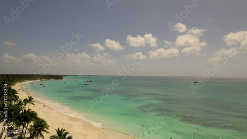 Caribbean White Sand Beach on a Tropical Isla Saona Island with Palm trees and Blue Water (Aerial Drone View in 4k)