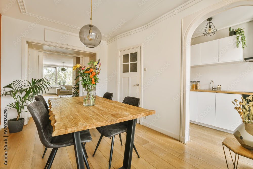 Dining room with wooden table and black chairs Dining room with wooden table and black chairs