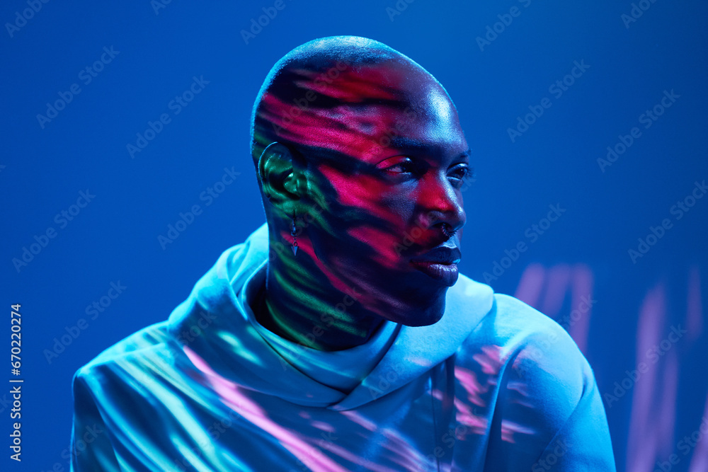 Black man thinking and looking away over blue background Black man thinking and looking away over blue background