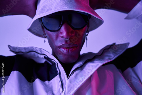 Closeup of Stylish black man wearing sunglasses and hat in studio photo