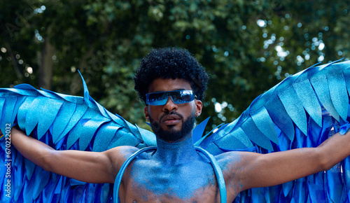 Man LGTBIQ+ in blue winged pride display photo