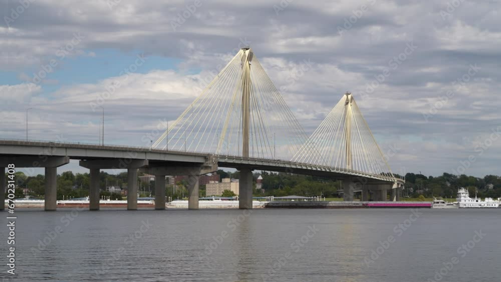 towboat with barges and a recreational boat are passing under the cable-stayed Clark Bridge on the Mississippi River at Alton, Illinois towboat with barges and a recreational boat are passing under the cable-stayed Clark Bridge on the Mississippi River at Alton, Illinois