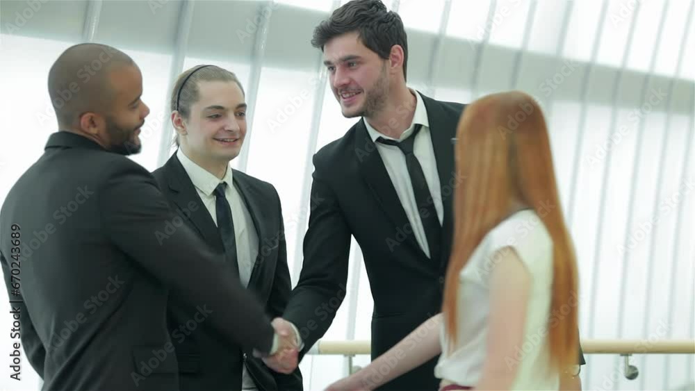 Two successful smiling businessmen shaking hands with each other Two successful smiling businessmen shaking hands with each other