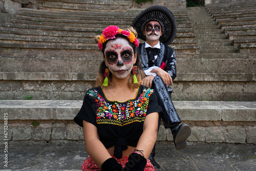 Couple dressed as mexican elegant catrines for day of the dead. Funny faces photo