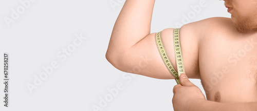 Stout man with measuring ta...
