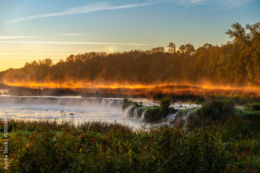 Sunrise over widest waterfall in Europe-Ventas Rumba in Kuldiga, Latvia, during sunrise in autumn