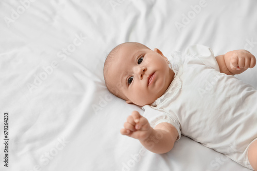 Little cute baby lying on bed at home