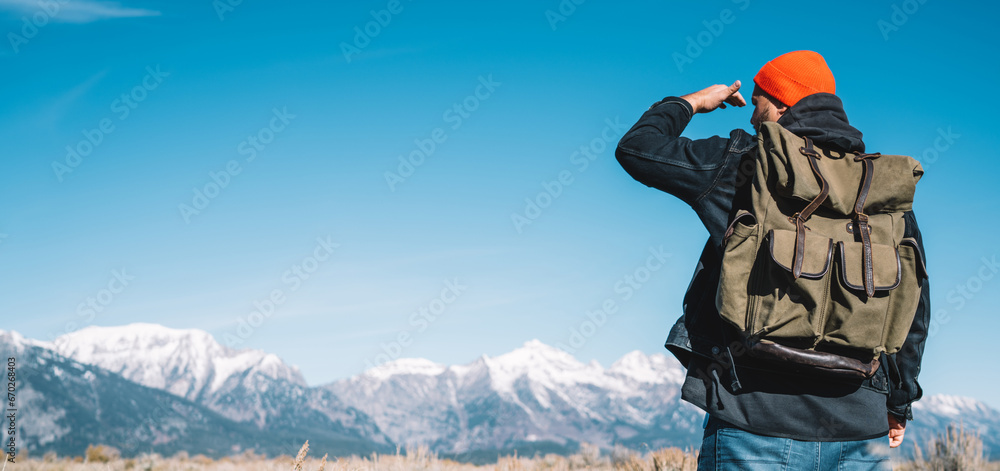 Young hipster guy enjoying breathtaking scenery of wild nature discover national park