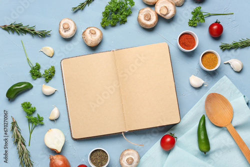Composition with blank open recipe book and different ingredients on color background