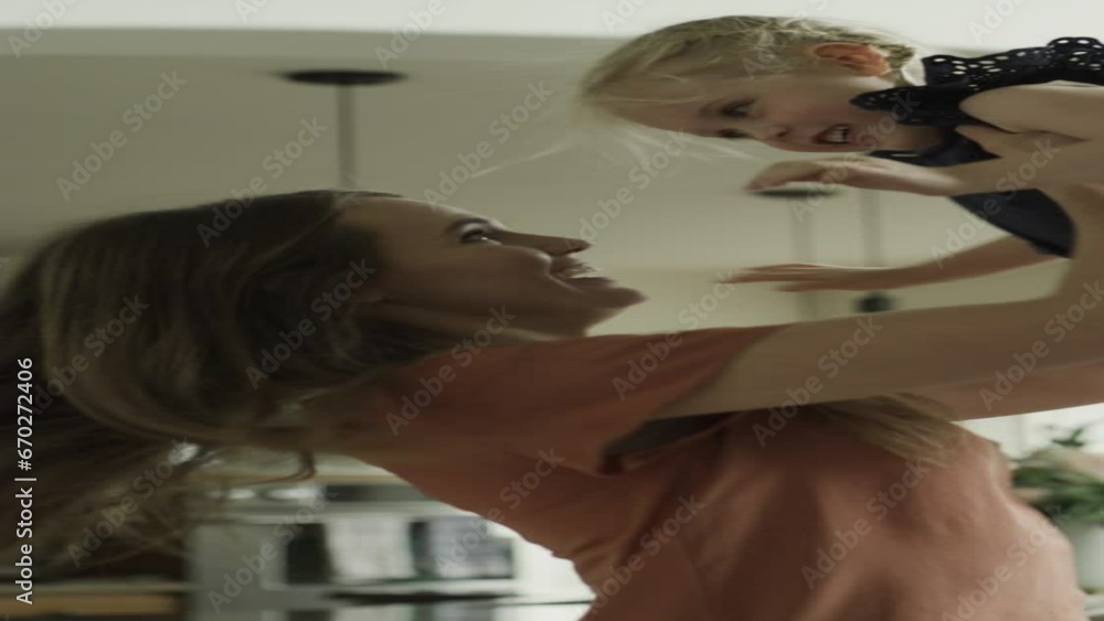 Slow motion of mother lifting and dancing with daughter - vertical video / Cedar Hills, Utah, United States Slow motion of mother lifting and dancing with daughter - vertical video / Cedar Hills, Utah, United States