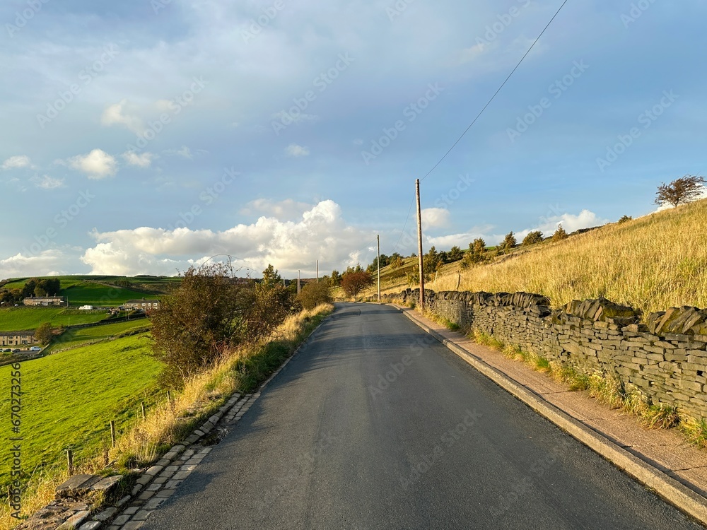 Evening autumn landscape, on Bradford Old Road, with dry stone walls, fields, and hills near, Halifax, UK