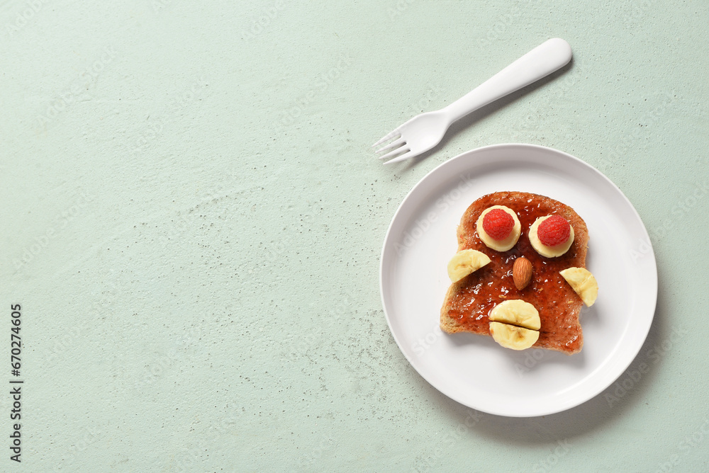 Plate with funny children's breakfast in shape of human face on grey table Plate with funny children's breakfast in shape of human face on grey table