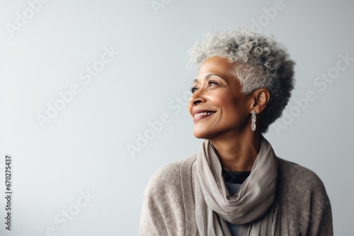 senior woman thinking with pensive expression against wall background. ai generated