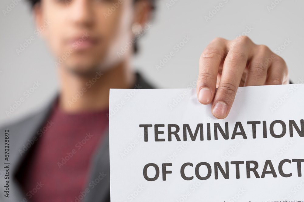 young unrecognizable man presents 'TERMINATION OF CONTRACT' noti young unrecognizable man presents 'TERMINATION OF CONTRACT' noti